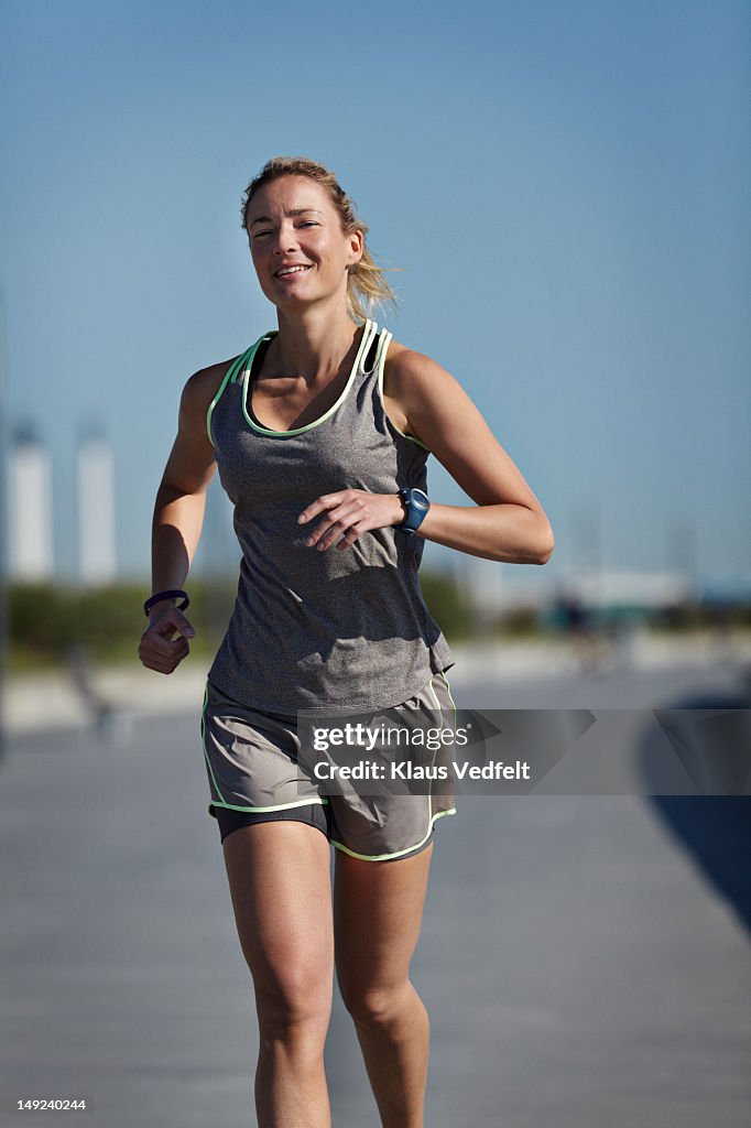 Woman running on beach road