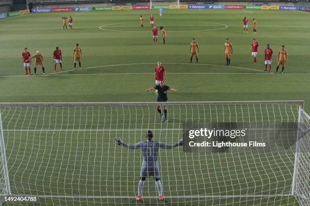a soccer referee firmly directs a goal keeper before a penalty kick - gameplay stock pictures, royalty-free photos & images