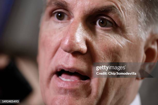 Surrounded by reporters, Speaker of the House Kevin McCarthy stops for what appears to be an impromptu live interview with CNN's Manu Raju in between...