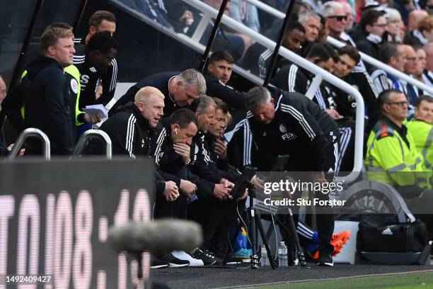 Dean Smith, Manager of Leicester City, and John Terry, First Team Coach of Leicester City are seen watching a replay on an analyst screen alongside...