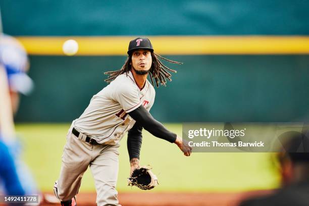 wide shot pitcher throwing to batter during professional baseball game - baseballschläger stock-fotos und bilder