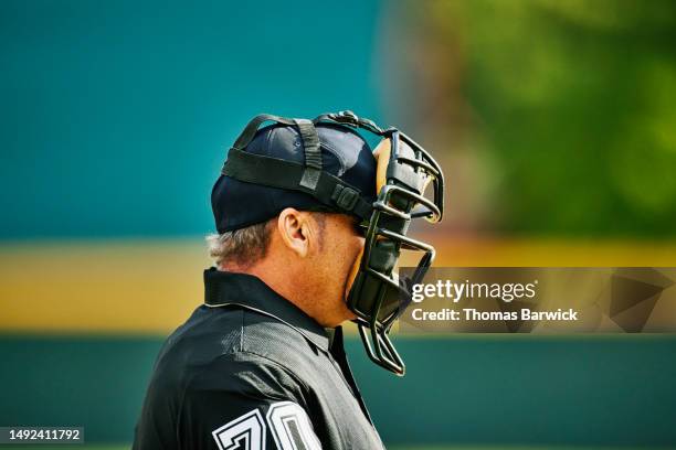 medium close up shot umpire behind home plate during baseball game - referee uniform stock pictures, royalty-free photos & images