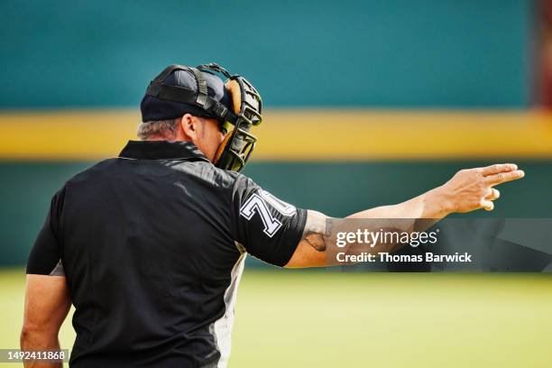 medium shot home plate umpire calling strike during baseball game - baseball umpire fotografías e imágenes de stock