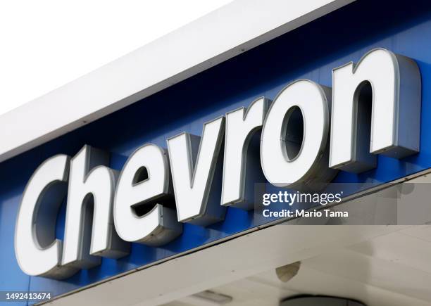 The Chevron logo is displayed at a Chevron gas station on May 22, 2023 in Los Angeles, California. Chevron is doubling down in the shale sector with...