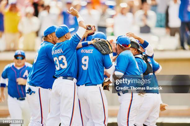 wide shot team celebrating with pitcher after winning baseball game - baseball team celebration stock pictures, royalty-free photos & images