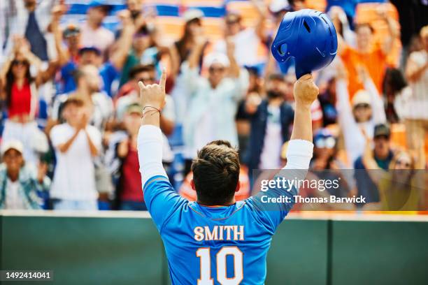 medium shot baseball player saluting crowd after hitting home run - baseball fans stock pictures, royalty-free photos & images