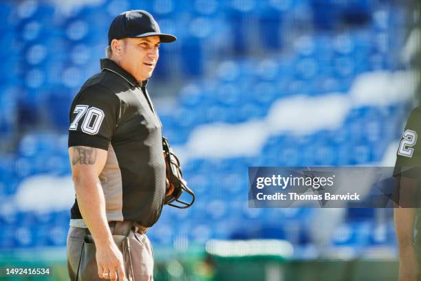 medium wide shot baseball umpire on field in stadium before game - referee shirt stock pictures, royalty-free photos & images