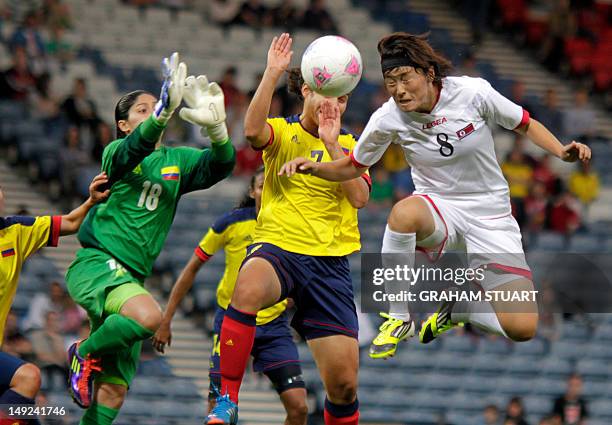 North Korea's Jon Myong Hwa vies with Colombia's Sandra Sepulveda and Orianica Velasquez during the Women's Olympic football match North Korea vs....