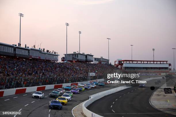 Daniel Suarez, driver of the Trackhouse Motorplex Chevrolet, leads the field at the start of the NASCAR Cup Series All-Star Race at North Wilkesboro...