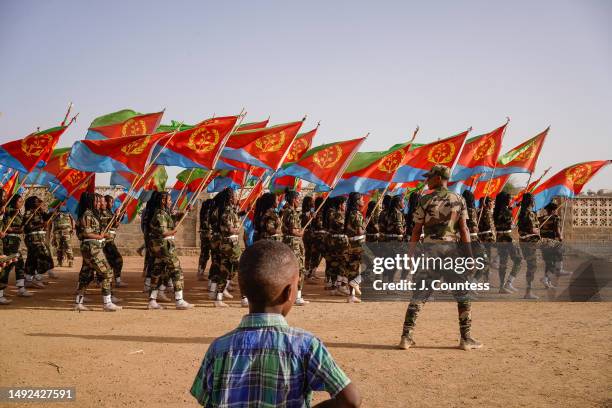 Child watches a procession of military flag bearers during an Independence Day celebration in Barentu, Eritrea on May 21, 2023 in Barentu, Eritrea....