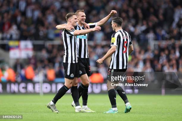 Sven Botman, Dan Burn and Fabian Schaer of Newcastle United celebrate after qualifying for the UEFA Champions League following the Premier League...
