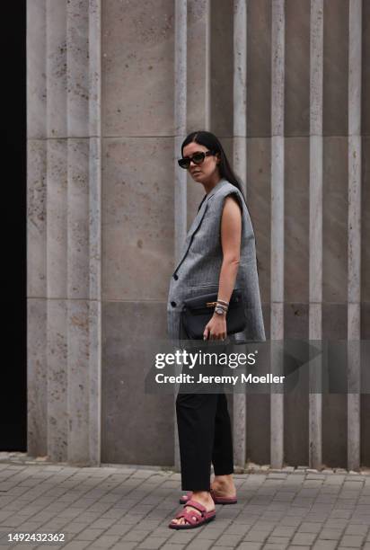 Leo Eberlin seen wearing Hermes Chypre velvet rose sandals, Revolve grey linen bra top and matching Revolve grey linen blazer vest, YSL brown shades,...