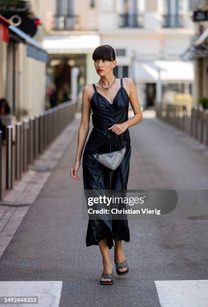 Katya Tolstova wears Prada bag, heeled sandals, black Margiela dress during the 76th Cannes film festival on May 22, 2023 in Cannes, France.