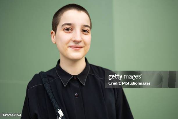 portrait of a transgender male looking at the camera. he is wearing black cool outfit - black transgender 個照片及圖片檔