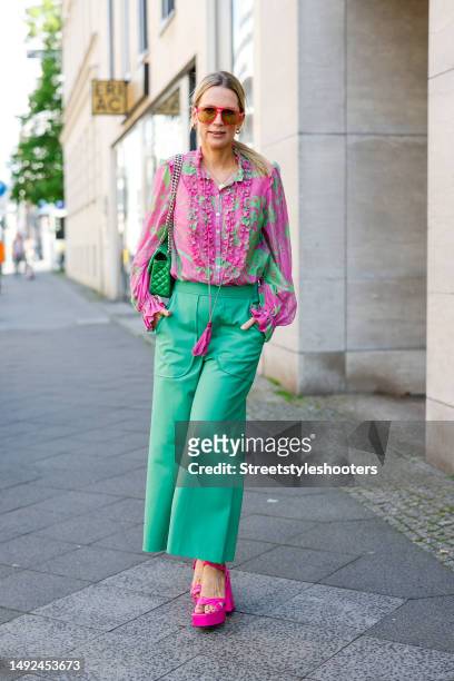 Influencer Tamara von Nayhauss, wearing green pants by Maison Common, a green-pink blouse with quilling by Maison common, pink colored high heel...