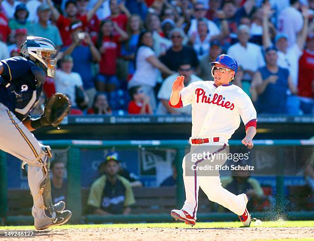 Mike Fontenot of the Philadelphia Phillies races home as he scores the game winning run on a single by teammate Jimmy Rollins in the 10th inning off...