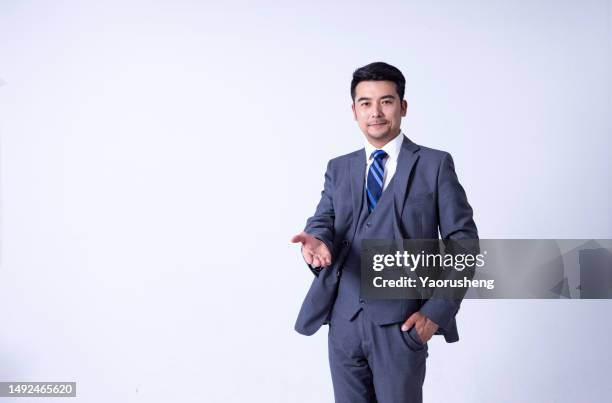 portrait of a confident  asian successful businessman against white background - pudong stock pictures, royalty-free photos & images