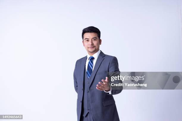 portrait of a confident  asian successful businessman against white background - pudong stock pictures, royalty-free photos & images