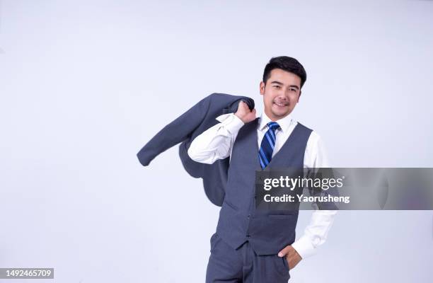 portrait of a confident  asian successful businessman against white background - pudong stock pictures, royalty-free photos & images