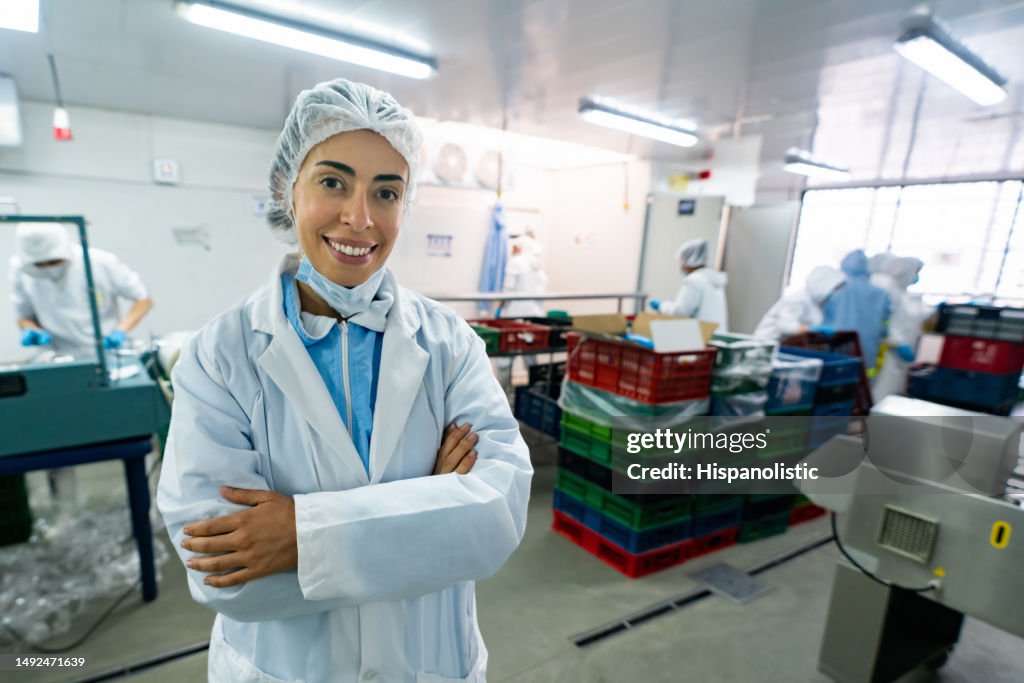 Happy woman working at a food processing plant