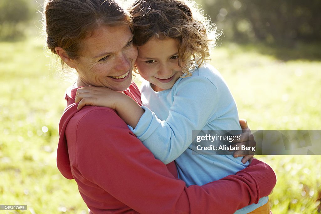 Mother and daughter cuddling together