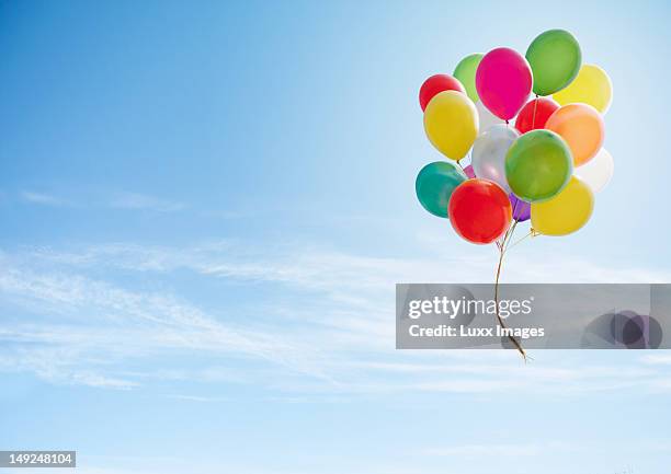 colorful bunch of balloons floating in the sky - cachorro-quente imagens e fotografias de stock