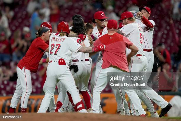 Nick Senzel of the Cincinnati Reds celebrates with teammates his walk-off sacrifice fly in the 10th inning to beat the St. Louis Cardinals 6-5 at...
