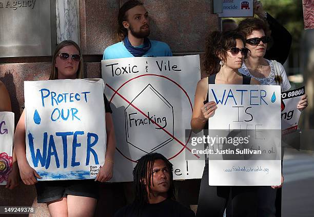 Protestors hold signs against fracking during a demonstration outside of the California Environmental Protection Agency headquarters on July 25, 2012...