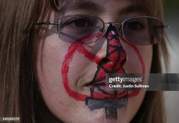 Protestor who identified herself as Kat wears face paint during a demonstration against fracking outside of the California Environmental Protection...