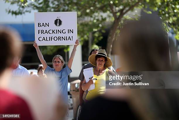 Protestor holds a sign against fracking during a demonstration outside of the California Environmental Protection Agency headquarters on July 25,...