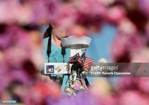 Wooden cross with the name and sailor's cap of shooting victim John Larimer, the Navy intelligence officer from Crystal Lake, Illinois, is viewd...