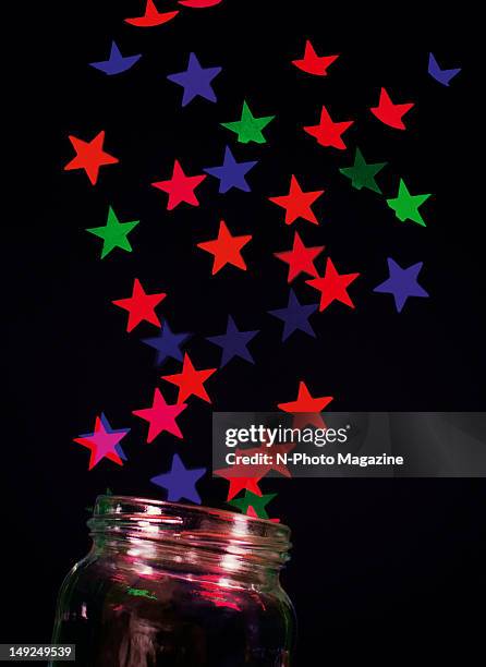 Abstract image of coloured stars streaming from an open glass jar, taken on October 12, 2011.
