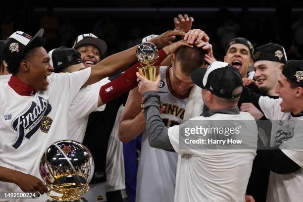 Nikola Jokic of the Denver Nuggets celebrates with teammates after receiving the Most Valuable Player Trophy following game four of the Western...