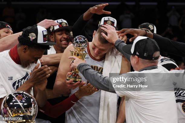 Nikola Jokic of the Denver Nuggets celebrates with teammates after receiving the Most Valuable Player Trophy following game four of the Western...