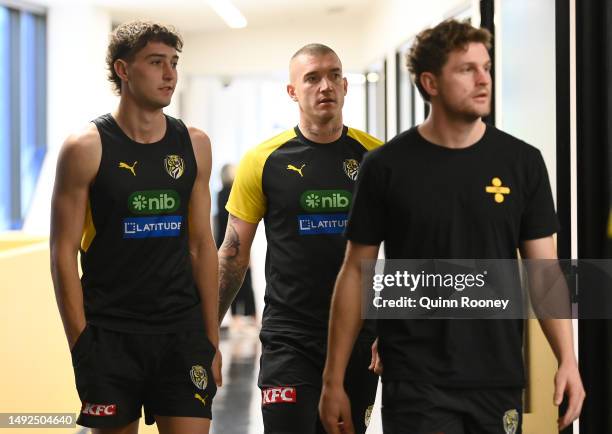 Dustin Martin and Jacob Hopper of the Tigers arrive to listen to Damien Hardwick the coach of the Tigers speak to the media during a Richmond Tigers...