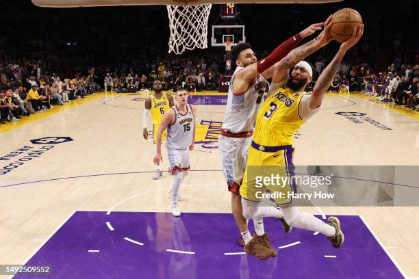 Anthony Davis of the Los Angeles Lakers is fouled by Jamal Murray of the Denver Nuggets during the fourth quarter in game four of the Western...