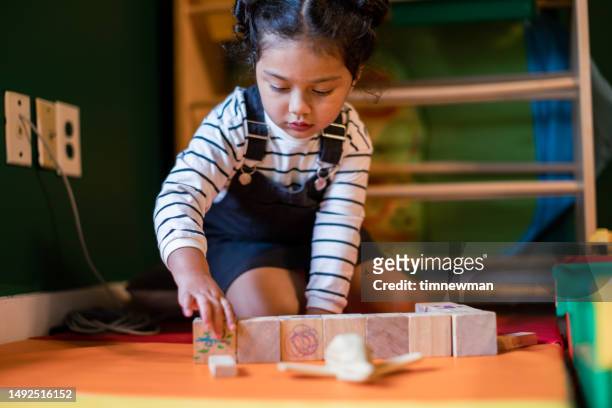 girl with autism spectrum disorder playing - autismus stock pictures, royalty-free photos & images
