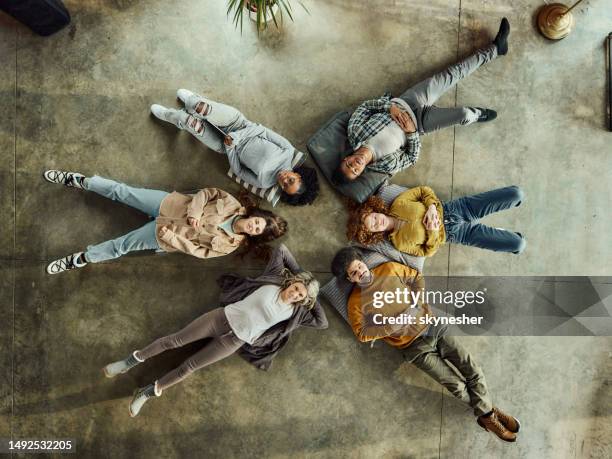 above view of young people resting on floor. - people looking down at camera stock pictures, royalty-free photos & images