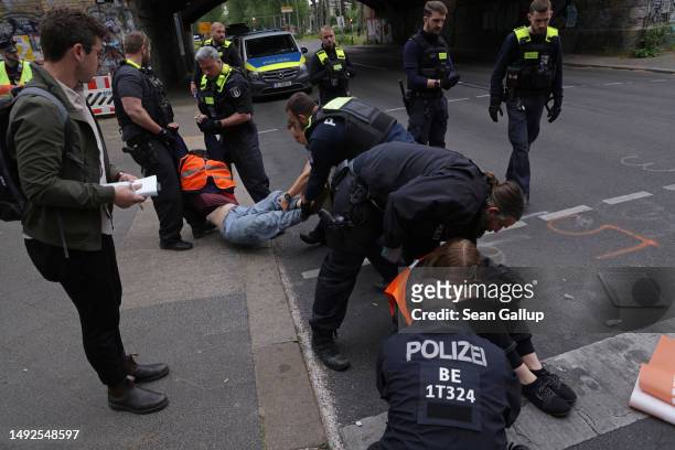 Police remove activists of the Last Generation climate action group who had blocked Puschkinallee avenue by gluing themselves to the asphalt on May...