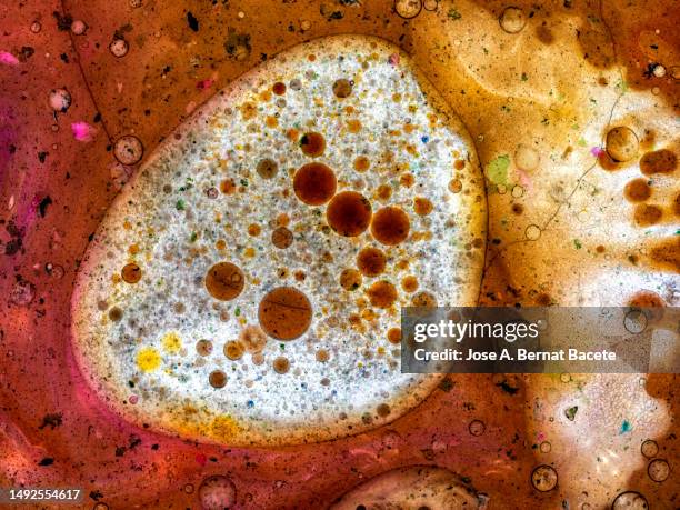 abstract background, colored liquids slide and mix on a rough surface. - food contamination stock pictures, royalty-free photos & images