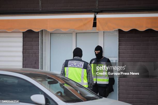 Two agents of the National Police at the door of a home, on 23 May, 2023 in Melilla, Spain. The National Police has started today in the morning an...