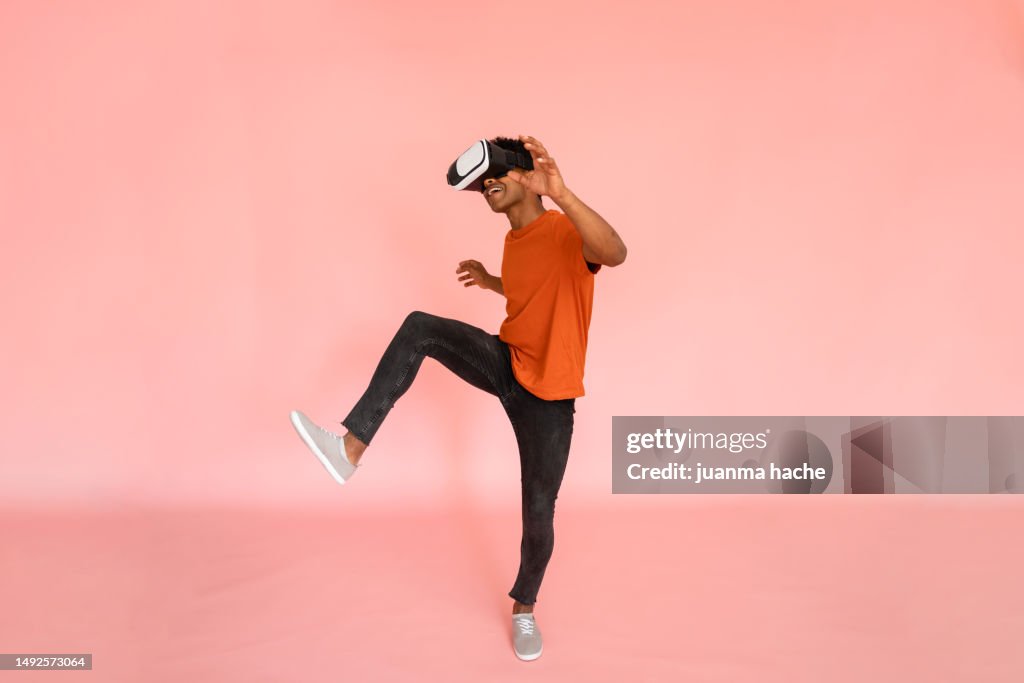 Full body side view of young male in VR goggles