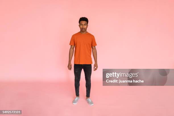 young african american male in orange shirt - model tshirt ストックフォトと画像