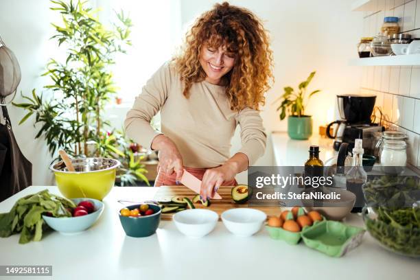 woman preparing salad - avocado slices stock pictures, royalty-free photos & images