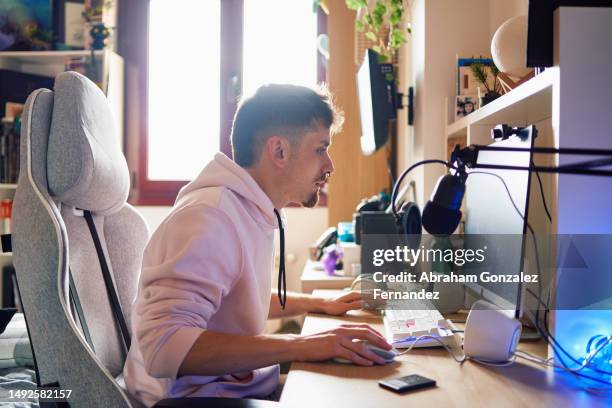 content creator using a computer in a home office - content creation stock pictures, royalty-free photos & images