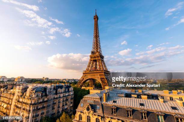 paris skyline with eiffel tower on a sunny day, wide angle view, france - paris stock-fotos und bilder