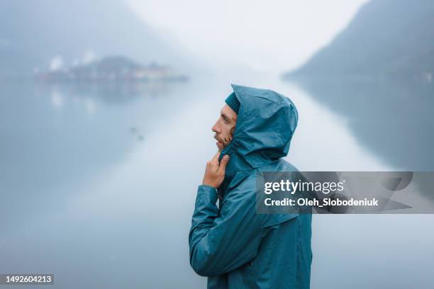 close up of raincoat made of recycled materials on the background of fjord in norway - polypropylene imagens e fotografias de stock