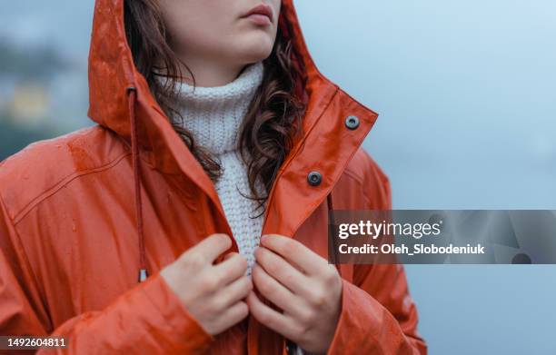 close up of raincoat made of recycled materials on the background of fjord in norway - polypropylene imagens e fotografias de stock