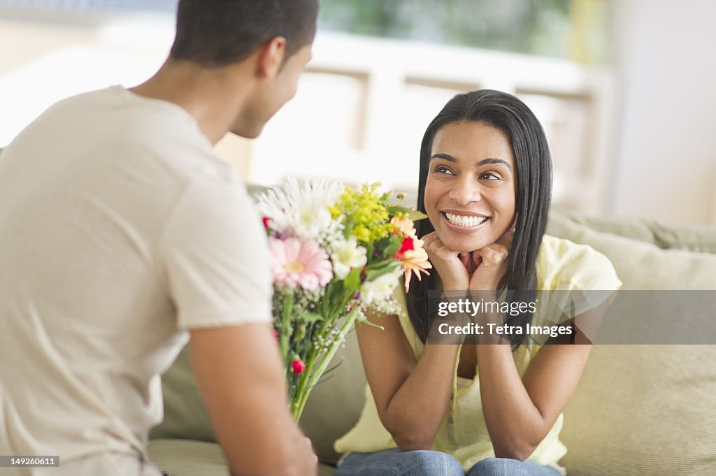 USA, New Jersey, Jersey City, Man giving bouquet of flowers to woman