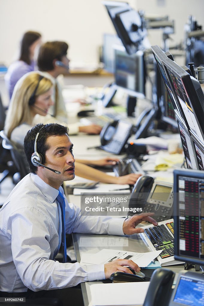 USA, New York, New York City, Traders at trading desk